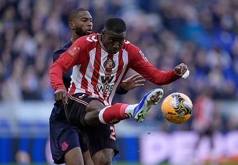 Everton's Beto, left, and Sunderland's Nordi Mukiele battle for the ball during the Emirates FA Cup third round match between Everton and Sunderland in Liverpool, England.