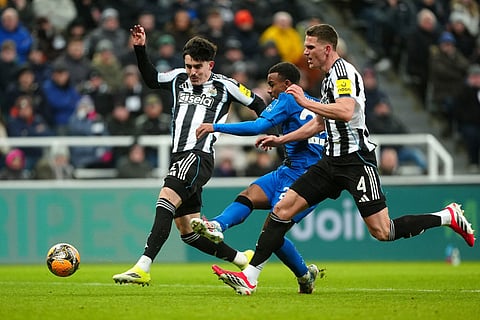 Bournemouth's Eli Junior Kroupi shoots under pressure from Newcastle United's Tino Livramento, left, and Sven Botman during the FA Cup third round soccer match between Newcastle United and Bournemouth in Newcastle, England.