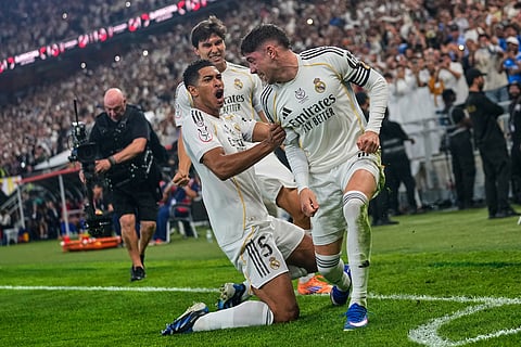 Real Madrid's Federico Valverde, right, is congratulated by Real Madrid's Jude Bellingham after scoring the opening goal during the Spanish Super Cup semifinal soccer match against Atletico Madrid at King Abdullah Sports City Stadium in Jeddah, Saudi Arabia.