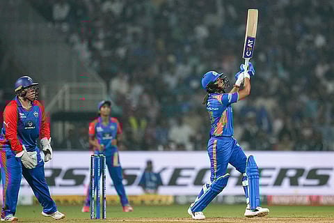 Mumbai Indians' captain Harmanpreet Kaur plays a shot during a Women's Premier League (WPL) T20 cricket match between Mumbai Indians and Delhi Capitals, at the DY Patil Stadium, in Navi Mumbai.