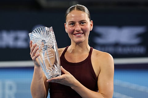 Marta Kostyuk of Ukraine poses with the runner up trophy after the women's final match against Aryna Sabalenka of Belarus 6-4, 6-3, at the Brisbane International tennis tournament in Brisbane, Australia.