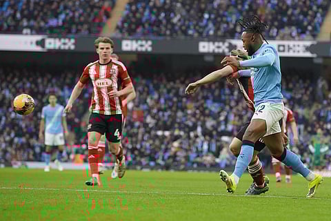 Manchester City's Antoine Semeny, front and Exeter's Ilmari Niskanen fight for the ball during the FA Cup third round match between Manchetster City and Exeter in Manchester, England.