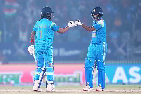 India's KL Rahul, left, and batting partner Washington Sundar touch gloves during the first One Day International cricket match between India and New Zealand in Vadodara, India.