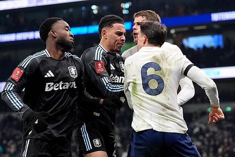 Aston Villa's Morgan Rogers, second left, and Tottenham Hotspur's Joao Palhinha, right, clash after the FA Cup third round soccer match between Tottenham Hotspur and Aston Villa in London.