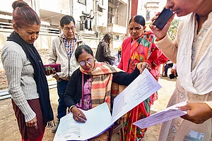 Photo: PTI : Voters check their names in the voter list during the Special Revision of Photo Electoral Rolls-2026 ahead of Assam Legislative Assembly elections, in Guwahati.