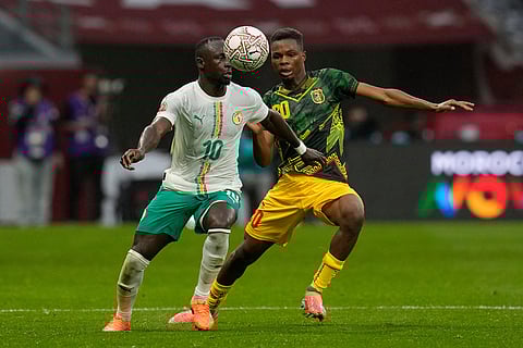 Senegal's Sadio Mane, left, and Mali's Mamadou Sangare fight for the ball during the Africa Cup of Nations quarterfinal soccer match between Senegal and Mali in Tangier, Morocco.
