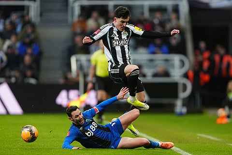 Bournemouth's Adam Smith, left, and Newcastle United's Tino Livramento battle for the ball during the FA Cup third round soccer match between Newcastle United and Bournemouth in Newcastle, England.