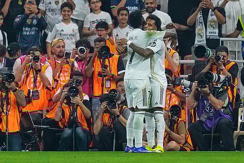 Real Madrid's Rodrygo, right, is congratulated by Real Madrid's Vinicius Junior after scoring his team second goal during the Spanish Super Cup semifinal soccer match against Atletico Madrid at King Abdullah Sports City Stadium in Jeddah, Saudi Arabia.