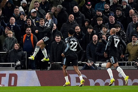 Aston Villa's Emi Buendia, left, celebrates scoring their side's first goal of the game during the FA Cup third round soccer match between Tottenham Hotspur and Aston Villa in London.