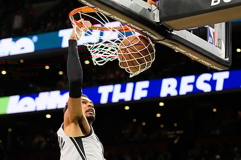 San Antonio Spurs forward Victor Wembanyama dunks against the Boston Celtics during the second half of an NBA basketball game in Boston.