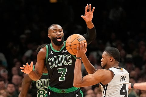 Boston Celtics guard Jaylen Brown (7) guards San Antonio Spurs guard De'aaron Fox (4) during the first half of an NBA basketball game in Boston.