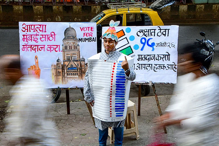 A student of the Gurukul School of Art wears an Electronic Voting Machine (EVM)-themed costume made of paper as part of a voter’s awareness campaign ahead of the Brihanmumbai Municipal Corporation (BMC) election, in Mumbai. - | Photo: PTI
