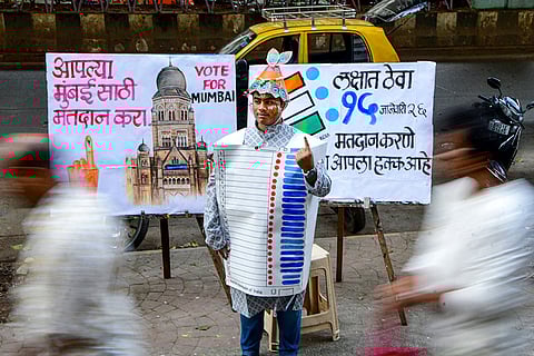 A student of the Gurukul School of Art wears an Electronic Voting Machine (EVM)-themed costume made of paper as part of a voter’s awareness campaign ahead of the Brihanmumbai Municipal Corporation (BMC) election, in Mumbai.