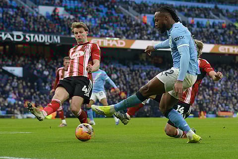 Manchester City's Antoine Semeny sends a cross by Exeter's Ilmari Niskanen fight for the ball during the FA Cup third round match between Manchetster City and Exeter in Manchester, England.