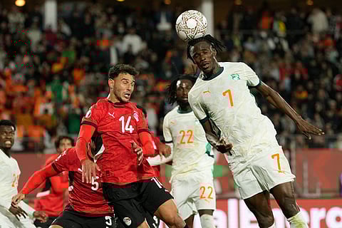 Ivory Coast's Odilon Kossounou, right, jumps for a header with Egypt's Hamdy Fathy during the Africa Cup of Nations quarterfinal soccer match between Egypt and Ivory Coast, in Agadir, Morocco.