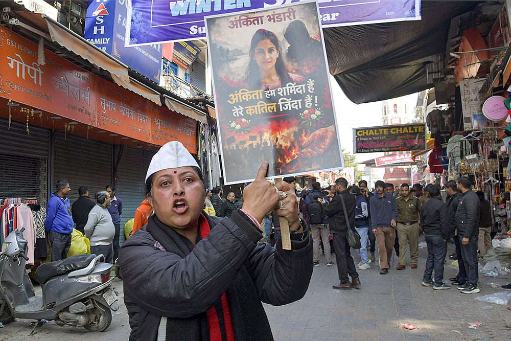 A protester holds a placard during a statewide bandh called by social groups and political organisations over the Ankita Bhandari murder case, in Dehradun. - | Photo: PTI