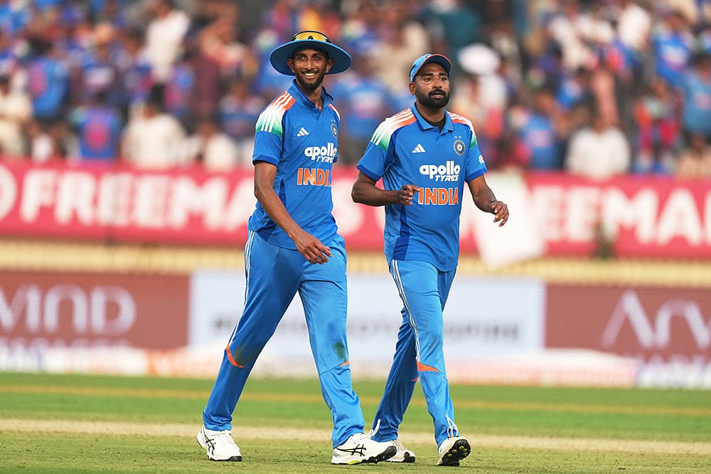 Indias Prasidh Krishna, left, and teammate Mohammed Siraj leave the field