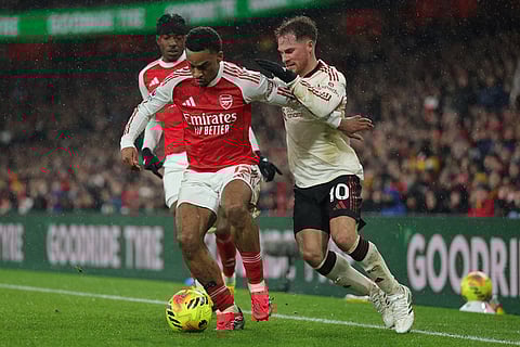 Arsenal's Jurrien Timber, left, and Liverpool's Alexis Mac Allister fight for the ballduring the English Premier League soccer match between Arsenal and Liverpool in London.