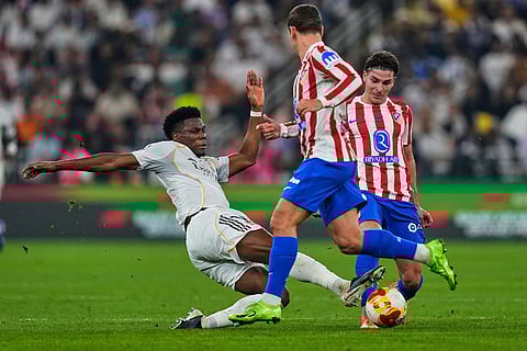 Real Madrid's Aurelien Tchouameni, left, duels for the ball with Atletico Madrid's Julian Alvarez, background, during the Spanish Super Cup semifinal soccer match at King Abdullah Sports City Stadium in Jeddah, Saudi Arabia.