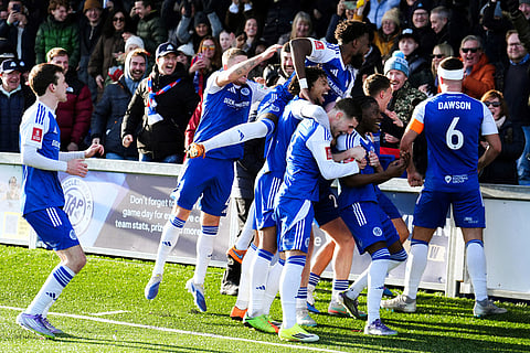 Macclesfield Town's Isaac Buckley-Ricketts celebrates scoring his side's second goal with teammates, during the FA Cup third round soccer match between Macclesfield Town and Crystal Palace, at the Leasing.com Stadium, Macclesfield, England.