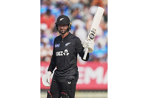 New Zealand's Devon Conway celebrates his fifty runs during the first One Day International cricket match between India and New Zealand in Vadodara, India.