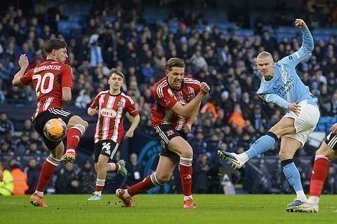 Manchester City's Erling Haaland shoots during the FA Cup third round match between Manchetster City and Exeter in Manchester, England.
