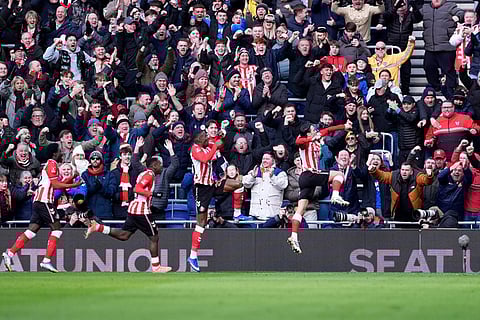 Sunderland's Enzo Le Fee, right, celebrates scoring their side's first goal of the game during the Emirates FA Cup third round match between Everton and Sunderland in Liverpool, England.
