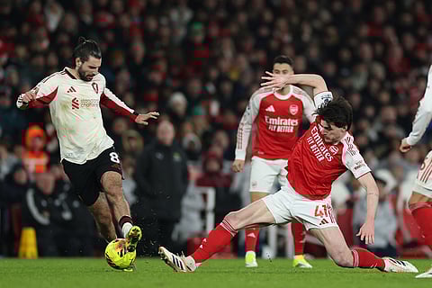 Liverpool's Dominik Szoboszlai, left, and Arsenal's Declan Rice fight for the ball during the English Premier League soccer match between Arsenal and Liverpool in London.
