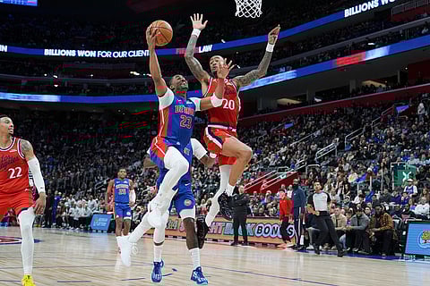 Detroit Pistons guard Jaden Ivey (23) shoots against Los Angeles Clippers forward John Collins (20) during the first half of an NBA basketball game in Detroit.