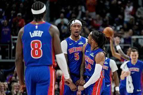 Detroit Pistons forward Ronald Holland II, center, celebrates with guard Caris LeVert, left, and guard Daniss Jenkins after scoring during the second half of an NBA basketball game against the Los Angeles Clippers in Detroit.