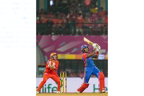 Delhi Capitals' Chinelle Henry plays a shot during a Women's Premier League (WPL) T20 cricket match between Gujarat Giants and Delhi Capitals, at the DY Patil Stadium, in Navi Mumbai.