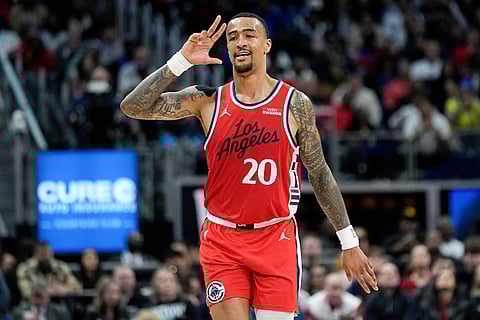 Los Angeles Clippers forward John Collins celebrates after a 3-point basket during the second half of an NBA basketball game against the Detroit Pistons in Detroit.
