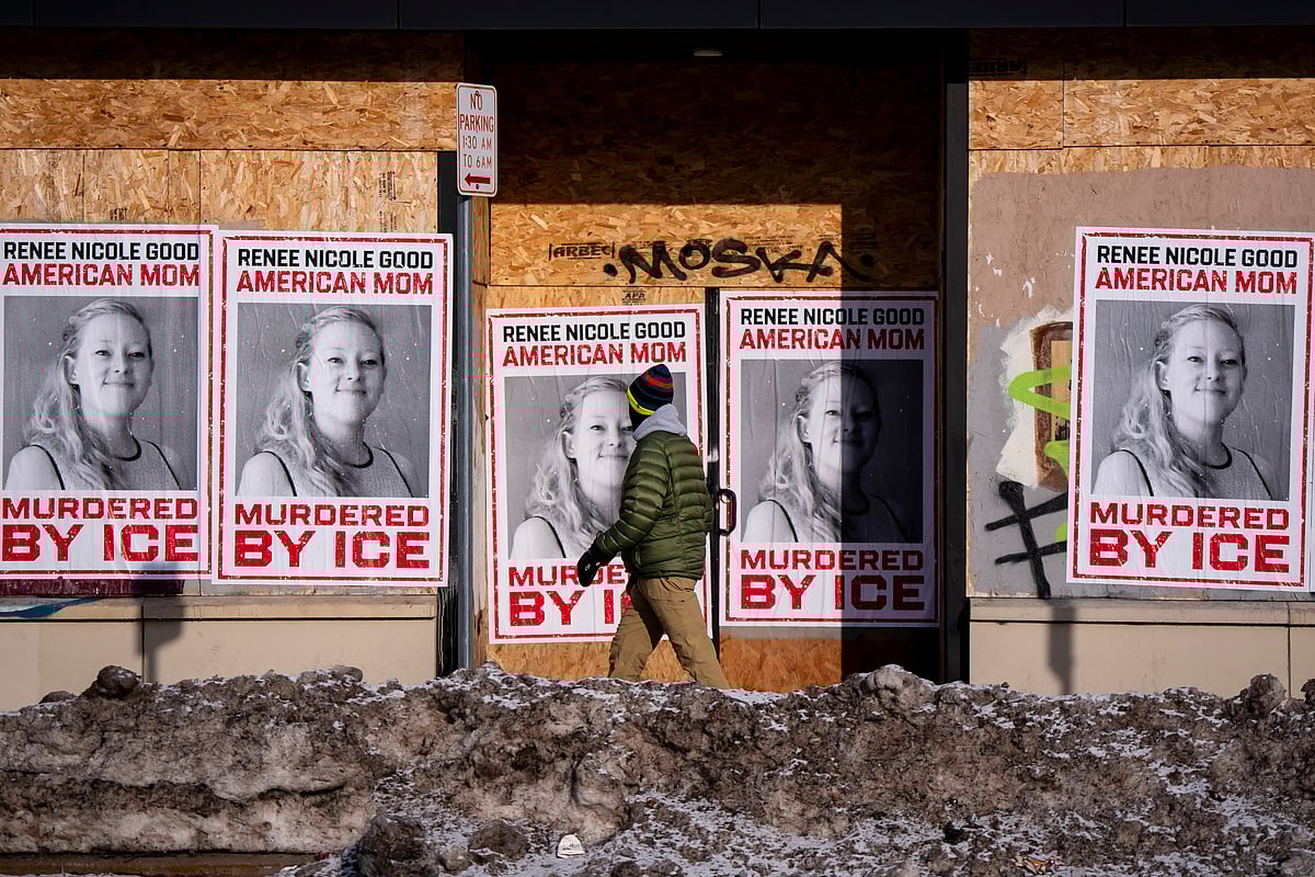 A person walks past signage for Renee Good, who was fatally shot by an ICE officer earlier in the week, in Minneapolis, Minn., Sunday, Jan. 11, 2026.  - Christopher Katsarov