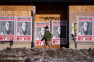 Christopher Katsarov : A person walks past signage for Renee Good, who was fatally shot by an ICE officer earlier in the week, in Minneapolis, Minn., Sunday, Jan. 11, 2026.