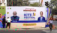 Source: IMAGO / ANI News : Workers in Ahmedabad install welcome hoardings for PM Modi and German Chancellor Friedrich Merz.