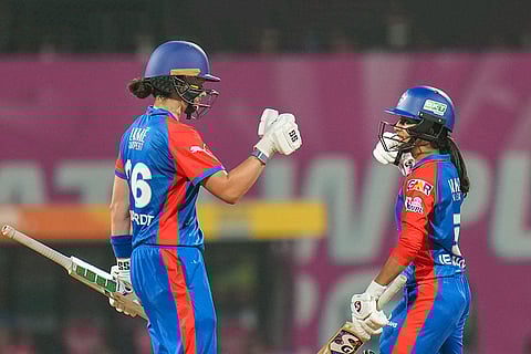 Delhi Capitals' Laura Wolvaardt, left, celebrates her half century with captain Jemimah Rodrigues during a Women's Premier League (WPL) T20 cricket match between Gujarat Giants and Delhi Capitals, at the DY Patil Stadium, in Navi Mumbai.