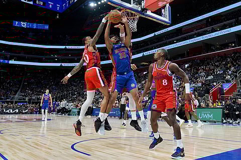 Detroit Pistons forward Tolu Smith, center, shoots against Los Angeles Clippers forward John Collins, forward Nic Batum, and guard Kris Dunn, from left, during the first half of an NBA basketball game in Detroit.