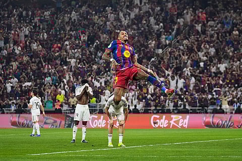 Barcelona's Raphinha celebrates after scoring his second goal during the Spanish Super Cup final soccer match against Real Madrid at King Abdullah Sports City Stadium in Jeddah, Saudi Arabia.