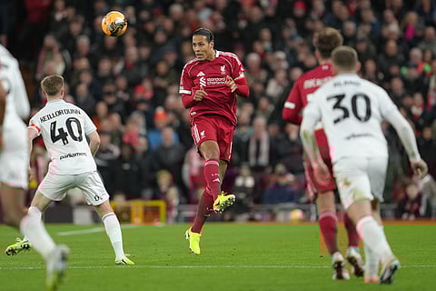 Liverpool's Virgil van Dijk heads the ball during the FA Cup third round soccer match between Liverpool and Barnsley in Liverpool, England.