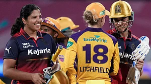 PTI : Royal Challengers Bengaluru's captain Smriti Mandhana, right, and Richa Ghosh, left, being congratulated by UP Warriorz's Phoebe Litchfield after winning the Women's Premier League.