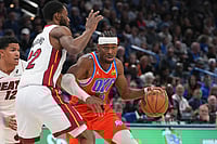| Photo: AP/Kyle Phillips : Oklahoma City Thunder guard Shai Gilgeous-Alexander, right, pushes past Miami Heat forward Andrew Wiggins during the second half of an NBA basketball game in Oklahoma City.