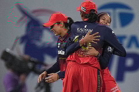Royal Challengers Bengaluru's captain Smriti Mandhana and Shreyanka Patil with teammate celebrate after the wicket of UP Warriorz's Phoebe Litchfield during a Women's Premier League (WPL) T20 cricket match between Royal Challengers Bengaluru and UP Warriorz, at the DY Patil Stadium in Navi Mumbai.