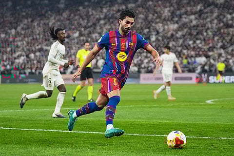 Barcelona's Ferran Torres runs with the ball during the Spanish Super Cup final soccer match against Real Madrid at King Abdullah Sports City Stadium in Jeddah, Saudi Arabia.