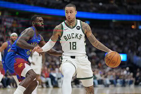Milwaukee Bucks forward Kyle Kuzma, right, drives past Denver Nuggets guard Tim Hardaway Jr., left, in the first half of an NBA basketball game in Denver.