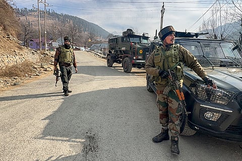 Anantnag: Security personnel stand guard during an ongoing search operation in the Gadol Kokernag area, in Anantnag.