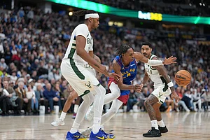 | Photo: AP/David Zalubowski : Denver Nuggets guard Peyton Watson, center, loses control of the ball while driving between Milwaukee Bucks center Myles Turner, front, and guard Gary Harris in the second half of an NBA basketball game in Denver.