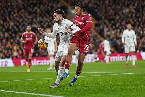 Barnsley's Corey O'Keeffe, left, and -mu73- fight for the ball during the FA Cup third round soccer match between Liverpool and Barnsley in Liverpool, England.