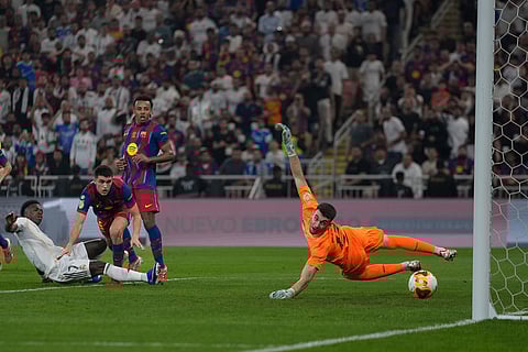 Real Madrid's Vinicius scores during the Spanish Super Cup final soccer match between Real Madrid and FC Barcelona at King Abdullah Sports City Stadium in Jeddah, Saudi Arabia.