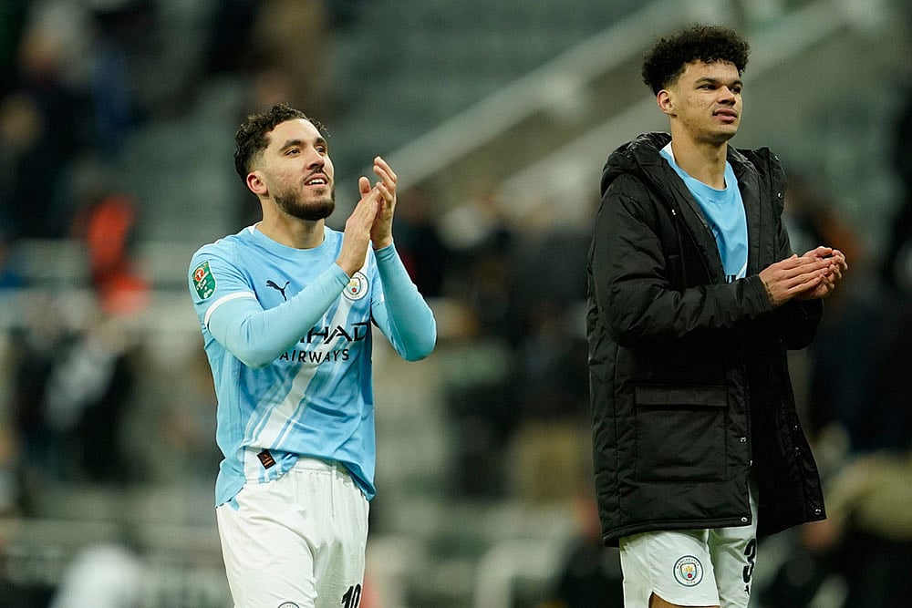 Manchester City's Rayan Cherki, left, and Manchester City's Nico O'Reilly applaud fans at the end of the English League Cup semifinal first leg soccer match between Newcastle and Manchester City in Newcastle, England. - Photo: AP/Dave Thompson