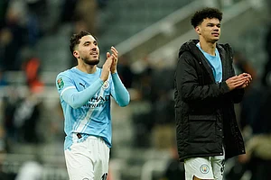 Photo: AP/Dave Thompson : Manchester City's Rayan Cherki, left, and Manchester City's Nico O'Reilly applaud fans at the end of the English League Cup semifinal first leg soccer match between Newcastle and Manchester City in Newcastle, England.